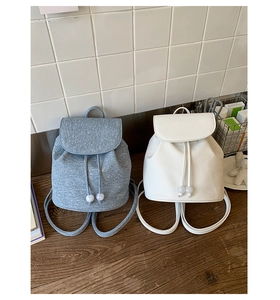 Detailed view of drawstring closure with clear beads on minimalist bucket backpacks