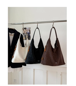 Minimalist leather tote bags in white, black and brown with wooden bead fringe detail