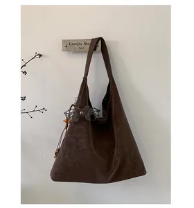 Close-up of vintage dark brown faux leather tote with PARTOR LONDON logo print