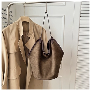 Detail view of coffee-colored frosted hobo shoulder bag with textured leather piping