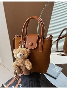 Brown frosted retro mini bucket bag with a plush bear pendant and smooth top handles