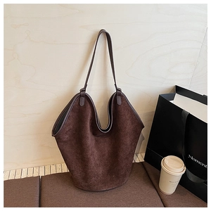 Detail of deep brown suede tote bag featuring a minimalist design and soft matte texture