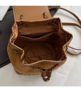 Detailed view of the drawstring bucket backpack interior with zip pocket and metal chain