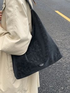 Vintage textured large capacity underarm tote bag in charcoal grey worn with beige coat