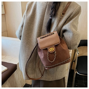 Detailed view of the vintage brown bucket backpack with gold buckle and chain straps
