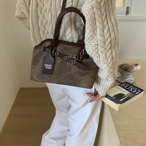 Detail of dark brown matte leather handbag with chain link and CIHO '2AD' tag