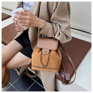 Detail of vintage suede bucket backpack with chain strap and gold twist-lock closure