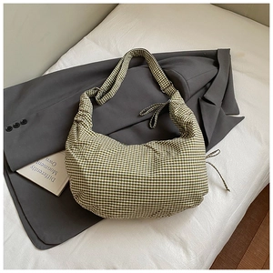 Close-up of green and white gingham crescent bag with stylish drawstring detail