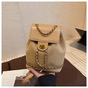 Detail view of khaki suede mini backpack with golden chain strap and twist lock