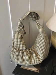 Green and white checkered crescent hobo bag with adjustable strap and drawstring details