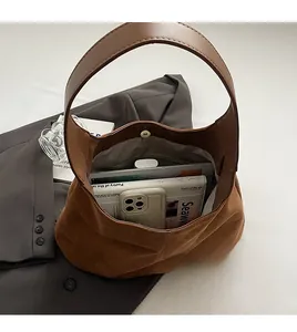 Interior view showing spacious capacity of the brown suede hobo tote with a magnetic clasp