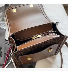 Close-up of leopard print detail and high-quality smooth zipper inside the brown leather bag