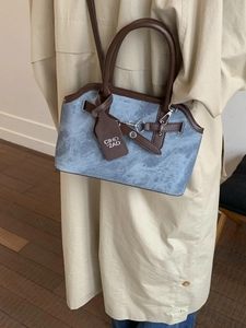 Chic marbled blue-grey crossbody handbag with dark brown leather straps and metal hardware