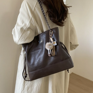 Chic dark brown vintage tote bag with metal chain strap and cute plush charm detail
