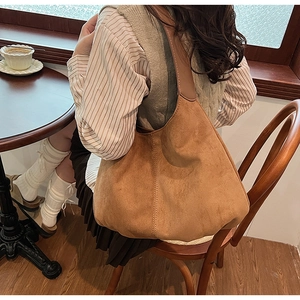 Detailed side view of a brown vintage faux suede tote bag showing large capacity and hobo shape