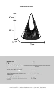 Detail view of large black Hobo bag with dual front zippers and adjustable strap