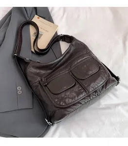 Close-up of deep brown litchi pattern leather shoulder bag with two front flap pockets