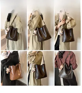 Detail view of large retro bucket bag with leopard charm in brown and black colors