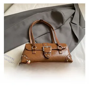 Close-up of vintage brown oil-wax leather shoulder bag with silver studs and buckles