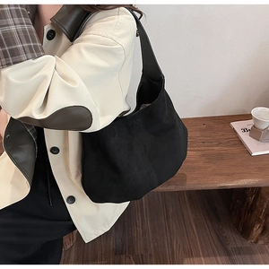 Detail view of the retro matte black hobo bag with vintage texture and stitched seams