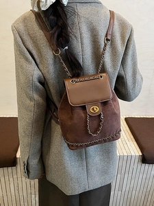 Mini brown suede and leather patchwork backpack with gold chain details on model back