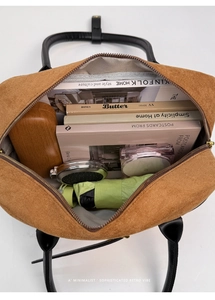 Top view of suede Boston bag interior showing large capacity with personal essentials