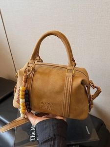 Brown suede Boston crossbody bag with decorative beaded tassel and adjustable shoulder strap