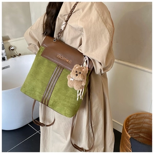 Retro green suede backpack with brown leather flap and cute plush bear charm detail