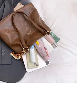 Brown vintage tote bag showing large capacity for tablet, umbrella, and accessories