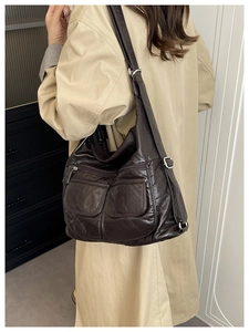 Detail of dark brown multifunctional shoulder bag with oil-wax texture and zip pockets