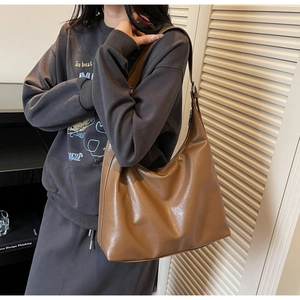 Brown leather hobo bag for women shown as a stylish large capacity shoulder tote bag