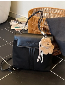 Black versatile school backpack with textured straps and cute bear charm pendant