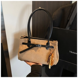Detail of khaki frosted tote bag with wooden bead charm and black double handles