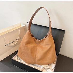 Brown suede shoulder bag elegantly presented in a black gift box with a thank you bag