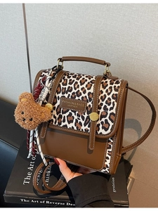 Brown leopard print patchwork handbag with plush bear pendant and stripe strap details
