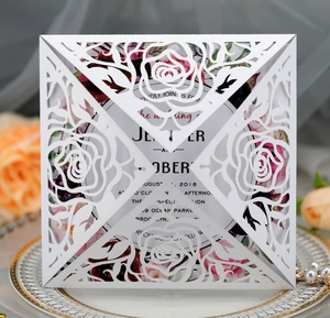 Detailed laser-cut rose hollow wedding invitation on elegant pearl white paper