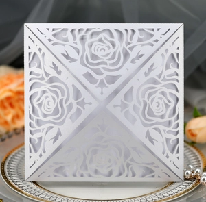 Macro detail of laser-cut rose floral pattern on pearlescent square wedding invitation