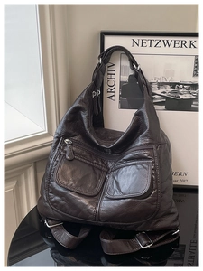 Detailed view of deep brown multipurpose soft leather bag with vintage texture and pockets