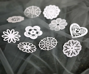 White laser-cut pearlescent paper flower and heart lace decorations for DIY crafts