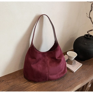 Detailed close-up showing the suede-like texture and stitching of this burgundy Hobo tote
