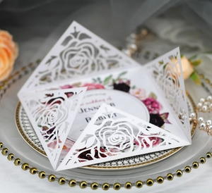 Detail of laser-cut rose hollow invitation with elegant floral wedding card
