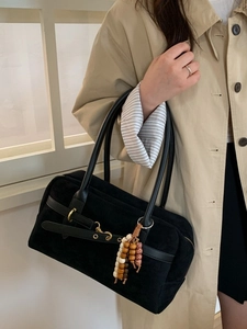 Large black suede Boston bag with leather straps and wooden beads shown on model