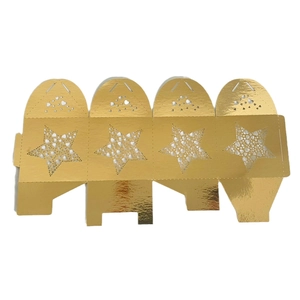 Flat lay of gold laser-cut star gift box showing five-pointed star and heart patterns