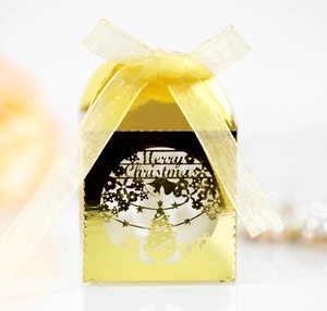 Golden laser-cut Christmas candy box with snowflake tree design and yellow ribbon