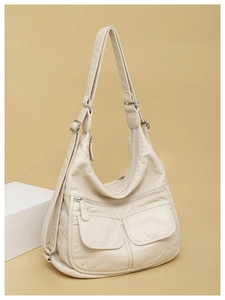Macro shot of cream white lychee texture faux leather with silver hardware zippers