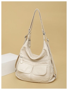 Detail view of large capacity cream soft leather multi-functional travel backpack