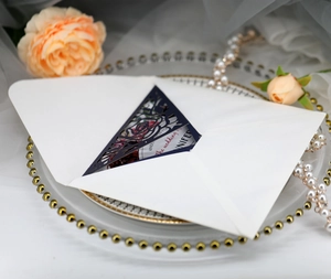 Detailed laser-cut rose hollow invitation card on decorative plate with pearls