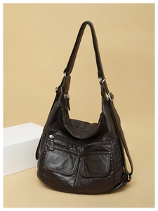 Close-up of brown PU leather bag with multi-pocket design and lychee texture details