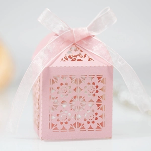 Detail of pink laser-cut floral gift box with an elegant white ribbon bow closure
