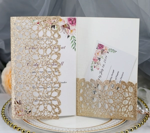 Detailed set of gold laser-cut glitter wedding invitations with pink floral inner cards